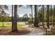 A beautiful park featuring tall trees, walking paths and scenic seating area with water view at 113 Moscato Ln, Summerville, SC 29485