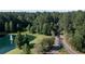 Aerial view of wooded property with a pond and fountain plus a private entry road at 1130 Plantation Overlook Dr, Moncks Corner, SC 29461