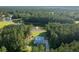 Aerial view of a home with a serene lake, lush greenery, and a private setting surrounded by trees at 1130 Plantation Overlook Dr, Moncks Corner, SC 29461