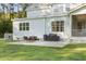 This backyard has a spacious patio, an outdoor dining table, and a grill, perfect for summer barbecues at 1130 Plantation Overlook Dr, Moncks Corner, SC 29461