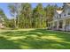 Spacious backyard with ample green space, extending from the home to the trees at 1130 Plantation Overlook Dr, Moncks Corner, SC 29461