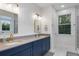 Elegant bathroom featuring double sinks, custom vanity, modern fixtures, and marble flooring at 1130 Plantation Overlook Dr, Moncks Corner, SC 29461
