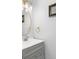Bright bathroom with gray cabinets, white countertop, brushed nickel faucet, gold framed mirror and a brushed gold towel ring at 1130 Plantation Overlook Dr, Moncks Corner, SC 29461