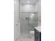 Stylish bathroom featuring a marble-tiled shower with glass door, blue vanity, and modern fixtures at 1130 Plantation Overlook Dr, Moncks Corner, SC 29461