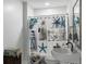 Cozy bathroom features decorative shower curtain with nautical theme, a classic vanity, and a framed mirror at 1130 Plantation Overlook Dr, Moncks Corner, SC 29461