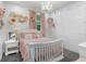 Bedroom featuring pink decor, white furniture, a chandelier, and an 'Adelaide Rose' themed wall at 1130 Plantation Overlook Dr, Moncks Corner, SC 29461