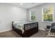 Bright bedroom featuring large windows, a comfortable bed, and a cozy rocking chair at 1130 Plantation Overlook Dr, Moncks Corner, SC 29461