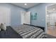 Bright bedroom with blue walls, plush carpeting, and view into dining room at 1130 Plantation Overlook Dr, Moncks Corner, SC 29461