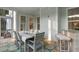 Outdoor patio featuring wood floors, a dining table set for eight, a seating area, and screen doors at 1130 Plantation Overlook Dr, Moncks Corner, SC 29461