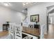 Well-lit dining room showcasing a wooden table, white chairs, modern chandelier, and stylish decor at 1130 Plantation Overlook Dr, Moncks Corner, SC 29461