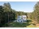 Expansive backyard with a charming two-story home nestled among mature trees and ample greenery at 1130 Plantation Overlook Dr, Moncks Corner, SC 29461