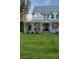 Charming two-story home featuring a grand wraparound porch, beautiful landscaping, and an inviting entrance at 1130 Plantation Overlook Dr, Moncks Corner, SC 29461