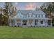 Expansive two-story home featuring a grand wraparound porch, beautiful landscaping, and charming curb appeal at 1130 Plantation Overlook Dr, Moncks Corner, SC 29461
