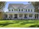 Beautiful two-story home with a wide front porch and manicured lawn, perfect for enjoying the outdoors at 1130 Plantation Overlook Dr, Moncks Corner, SC 29461