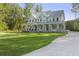 Expansive lawn frames this gorgeous home with welcoming wrap-around porch at 1130 Plantation Overlook Dr, Moncks Corner, SC 29461