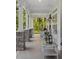 Spacious covered porch featuring stone accents, comfortable seating, and a decorative lantern, perfect for relaxing outdoors at 1130 Plantation Overlook Dr, Moncks Corner, SC 29461