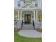 Classic home entrance with a charming front porch, stone columns, and a welcoming double door adorned with wreaths at 1130 Plantation Overlook Dr, Moncks Corner, SC 29461