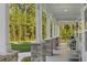 Covered front porch with stone columns, rocking chairs, and serene wooded views providing a relaxing outdoor space at 1130 Plantation Overlook Dr, Moncks Corner, SC 29461