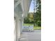 Garage exterior with a white wooden fence, leading to a backyard with a view of lush green trees at 1130 Plantation Overlook Dr, Moncks Corner, SC 29461