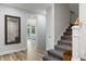 Hallway view showcases hardwood floors, staircase, mirror, and entrance to a bedroom at 1130 Plantation Overlook Dr, Moncks Corner, SC 29461
