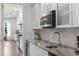 Well-equipped kitchen with stainless steel appliances, marble countertops, and stylish white cabinetry at 1130 Plantation Overlook Dr, Moncks Corner, SC 29461