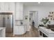 Modern kitchen featuring white cabinets, stainless steel refrigerator, and easy access to the living area at 1130 Plantation Overlook Dr, Moncks Corner, SC 29461