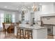Bright kitchen with marble countertops, a kitchen island with seating, and modern light fixtures at 1130 Plantation Overlook Dr, Moncks Corner, SC 29461