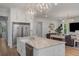 Modern kitchen with a large island, white cabinetry, and seamless connectivity to the living area at 1130 Plantation Overlook Dr, Moncks Corner, SC 29461