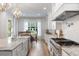 Gourmet kitchen with stainless steel appliances, a farmhouse sink, and an adjacent dining area with natural light at 1130 Plantation Overlook Dr, Moncks Corner, SC 29461