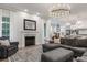 Open-concept living room with fireplace, hardwood floors, and seamless access to a modern kitchen at 1130 Plantation Overlook Dr, Moncks Corner, SC 29461
