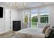Main bedroom boasts beautiful views, hardwood floors, a chandelier, and a walk out balcony at 1130 Plantation Overlook Dr, Moncks Corner, SC 29461