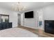 A lavish bedroom features a chandelier, dark wood dresser, and access to a bathroom at 1130 Plantation Overlook Dr, Moncks Corner, SC 29461