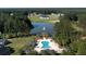 Aerial view of neighborhood pool, clubhouse, and lakefront homesites in lush forest setting at 1130 Plantation Overlook Dr, Moncks Corner, SC 29461