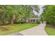 Charming brick home with mature trees, lush lawn, and a long driveway at 1225 Dennis Blvd, Moncks Corner, SC 29461