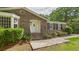 Inviting brick home exterior showcasing the front entrance with landscaped garden beds at 1225 Dennis Blvd, Moncks Corner, SC 29461