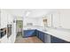 Well-lit kitchen featuring white upper cabinets, dark blue lower cabinets, and modern appliances at 1225 Dennis Blvd, Moncks Corner, SC 29461