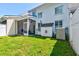 Spacious backyard with green lawn, white siding, dog house, AC Unit and partial privacy fence at 143 Dorothy Dr, Charleston, SC 29414