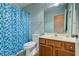 Cozy bathroom with blue shower curtain, wood cabinet sink, and soft lighting at 143 Dorothy Dr, Charleston, SC 29414