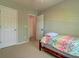 Modest bedroom with neutral walls, multiple doors, carpet and a bed with colorful zigzag patterned bedding at 143 Dorothy Dr, Charleston, SC 29414