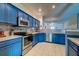 This kitchen features stainless appliances, painted cabinetry, and tile flooring at 143 Dorothy Dr, Charleston, SC 29414