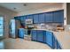 Bright kitchen featuring stainless steel appliances and blue cabinets at 143 Dorothy Dr, Charleston, SC 29414