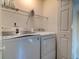 Functional laundry room with modern washer and dryer, ample shelving for storage, and a pristine, organized design at 143 Dorothy Dr, Charleston, SC 29414