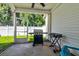 Covered, screened in porch offers relaxed outdoor living space with a grill and seating, perfect for entertaining at 143 Dorothy Dr, Charleston, SC 29414