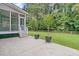 An inviting backyard features a screened porch and an open patio with mature trees beyond at 1436 Lagoon Park Cir, Mount Pleasant, SC 29466