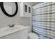 Bathroom features a white vanity with a round mirror and a shower with a colorful curtain at 1436 Lagoon Park Cir, Mount Pleasant, SC 29466