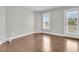 Bedroom features wood floors, a large window, and a glass door accessing the outside at 1436 Lagoon Park Cir, Mount Pleasant, SC 29466