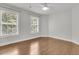 An empty bedroom features two windows and wood floors at 1436 Lagoon Park Cir, Mount Pleasant, SC 29466