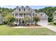 Inviting home featuring a well-manicured lawn, double porches and an attached two car garage at 1436 Lagoon Park Cir, Mount Pleasant, SC 29466