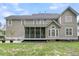 The back of this home features a screened-in porch and classic neutral vinyl siding at 1436 Lagoon Park Cir, Mount Pleasant, SC 29466