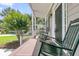 Relaxing front porch featuring rocking chairs, views of the lush landscaped front yard at 1436 Lagoon Park Cir, Mount Pleasant, SC 29466